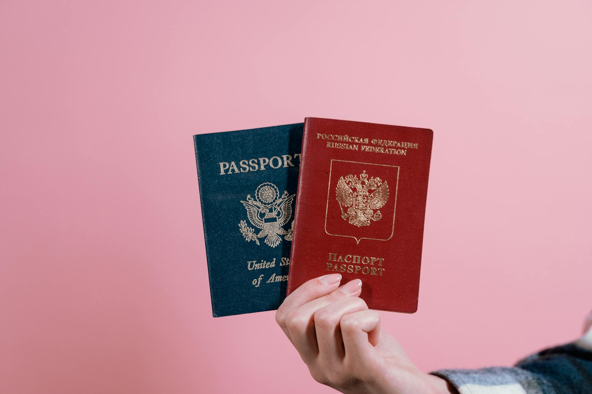 https://www.pexels.com/photo/person-holding-red-and-blue-book-7009611/