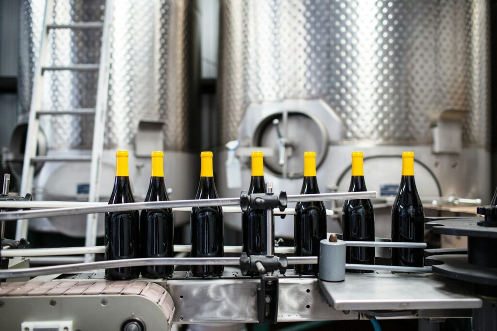 black glass bottles on stainless steel rack